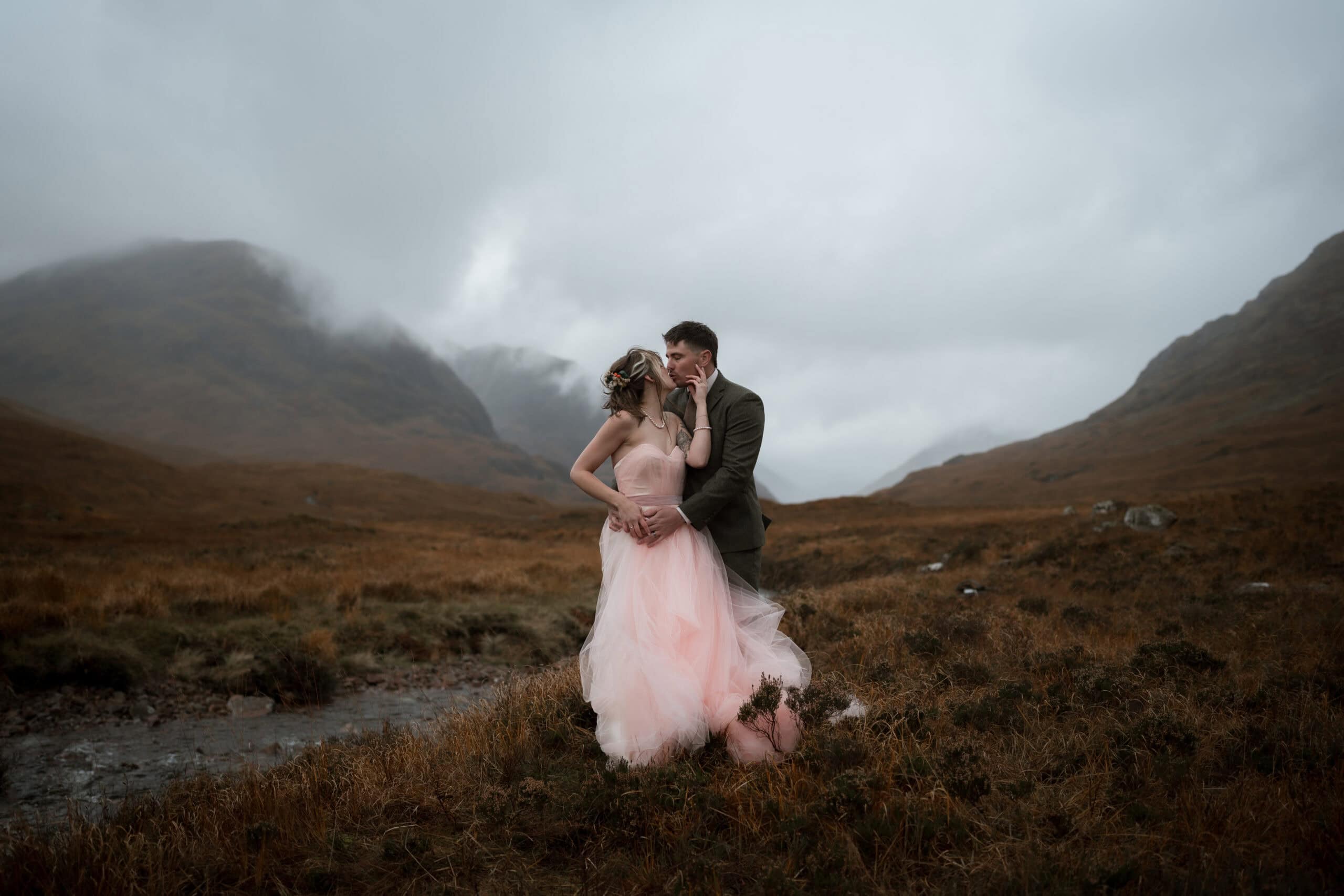 Romantic elopement photography in Glencoe, Scottish Highlands, with misty peaks and rugged scenery.