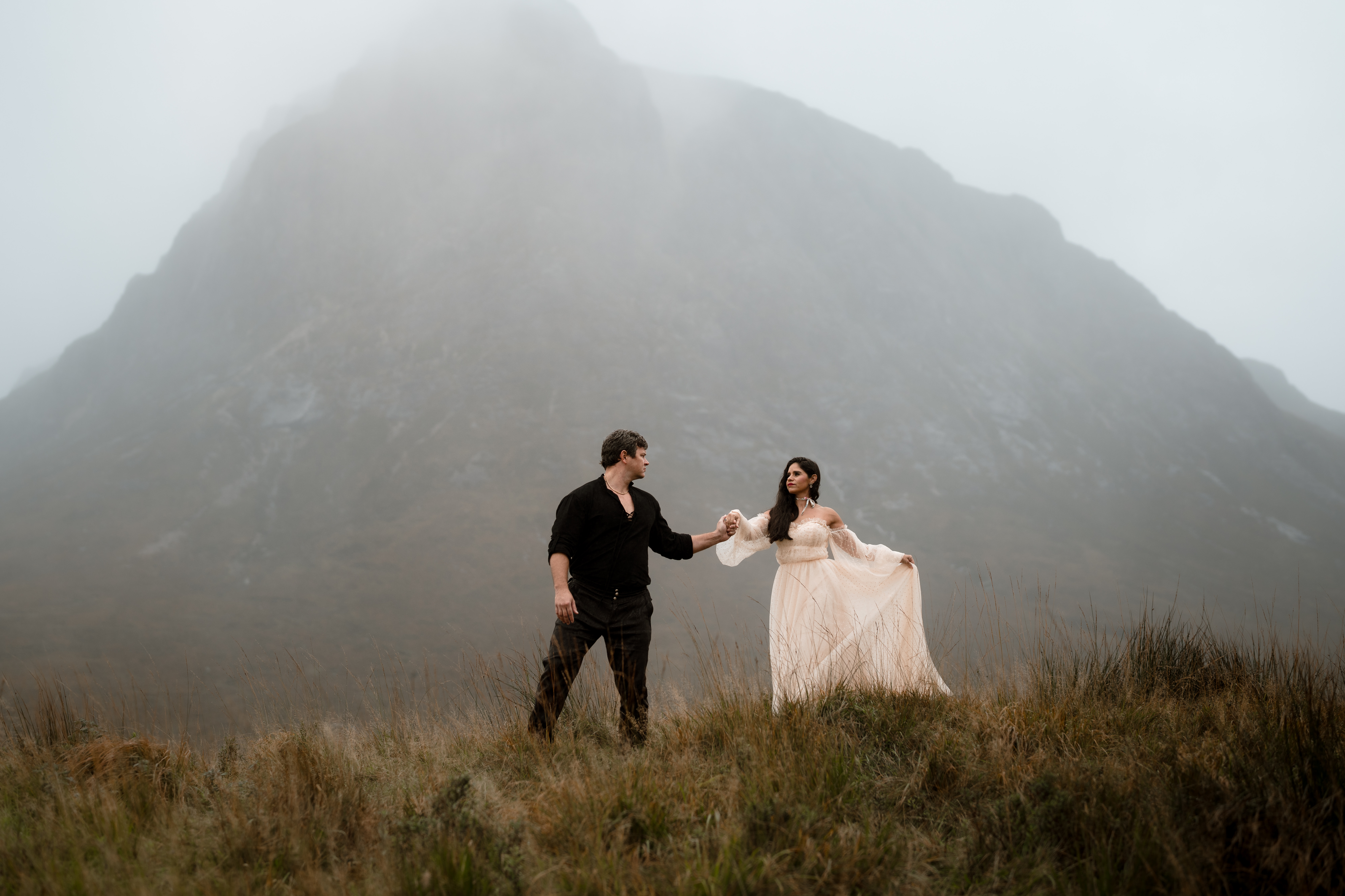 A couple photographed in the Scottish Highlands in soft evening light
