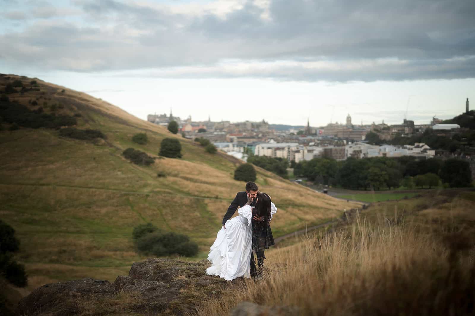 Couple eloping on Arthur’s Seat above Edinburgh
